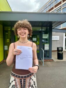Charley Dean holding her results